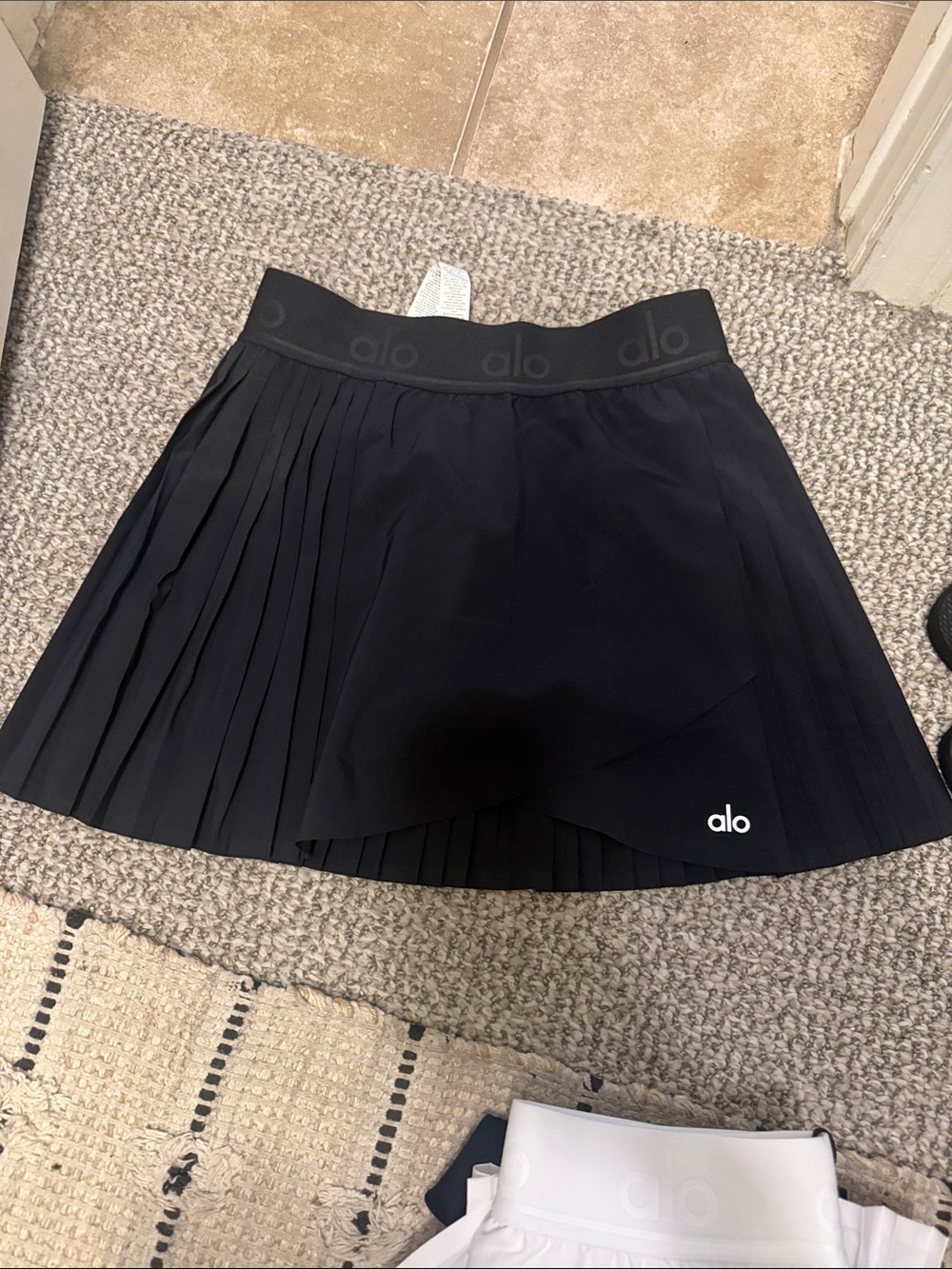 ALO Yoga Black Pleated tennis Skirt with Logo Waistband and shorts underneath